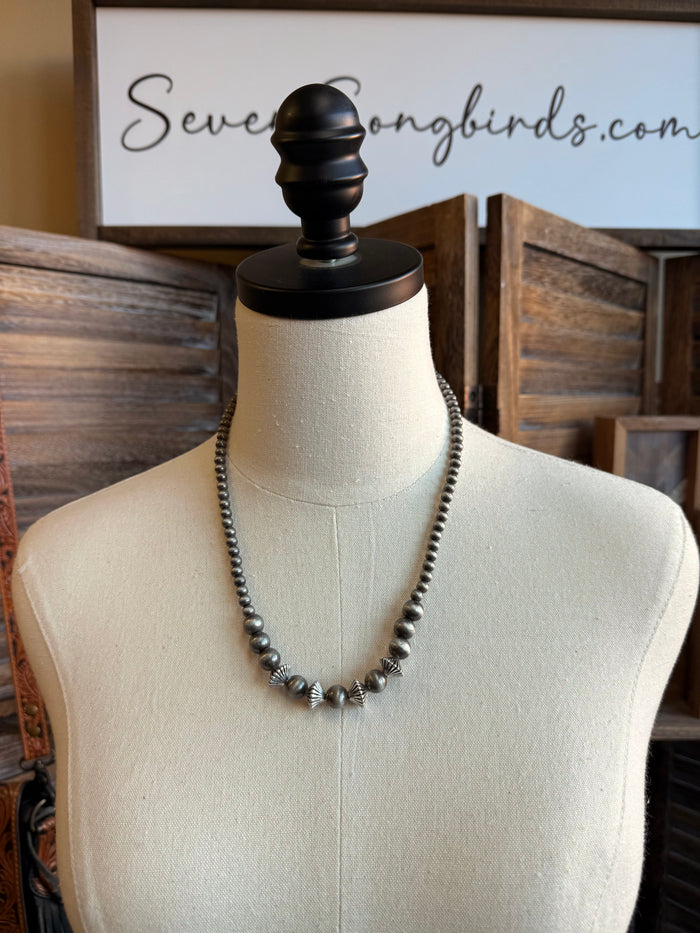 Silver pearl rondelle necklace, long graduated design on mannequin