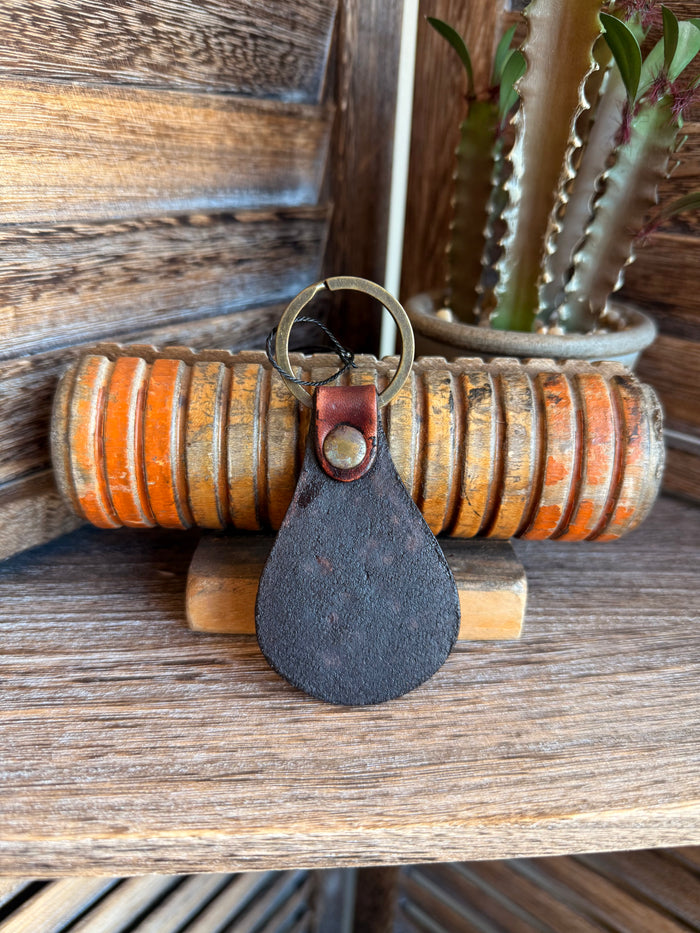 Brown leather keychain with metal ring and round snap button, plain teardrop shape