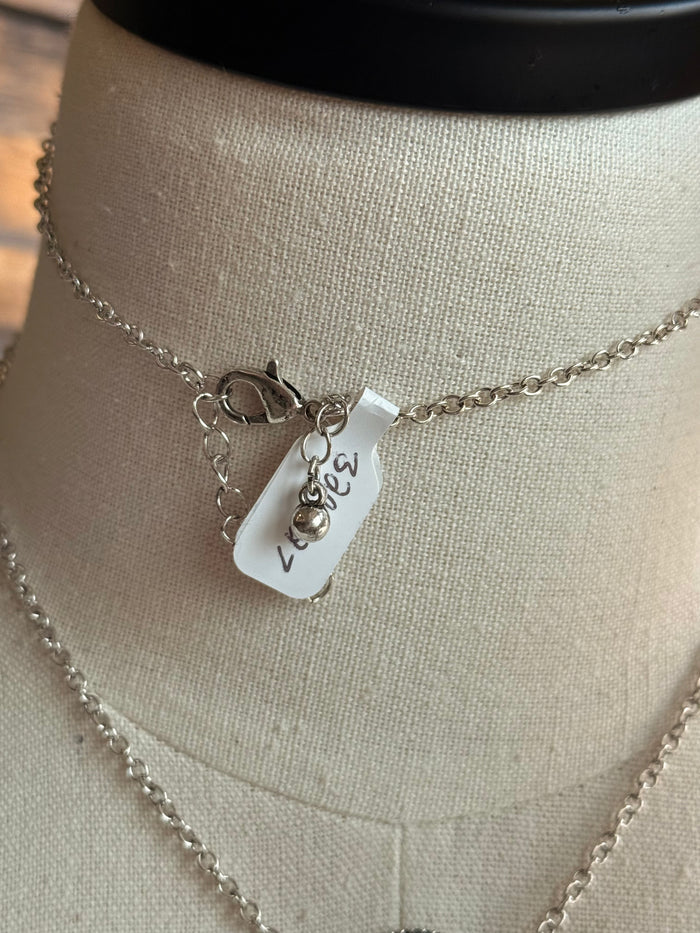 Silver chain necklace with lobster clasp and small hanging charm tag