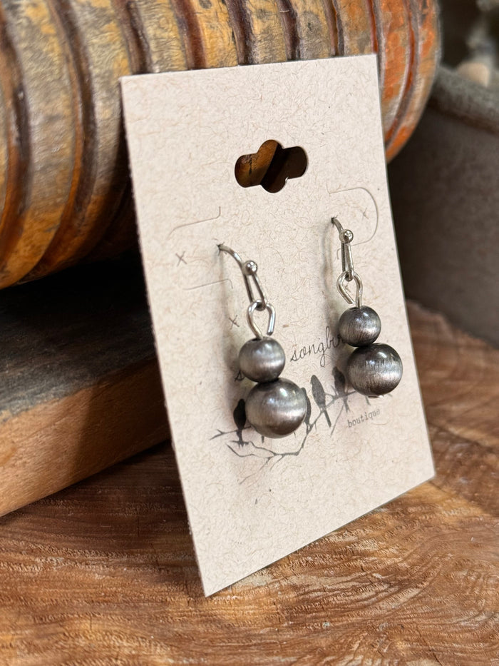 Silver-tone mini dangle earrings close-up with stacked round drops and fishhook hooks