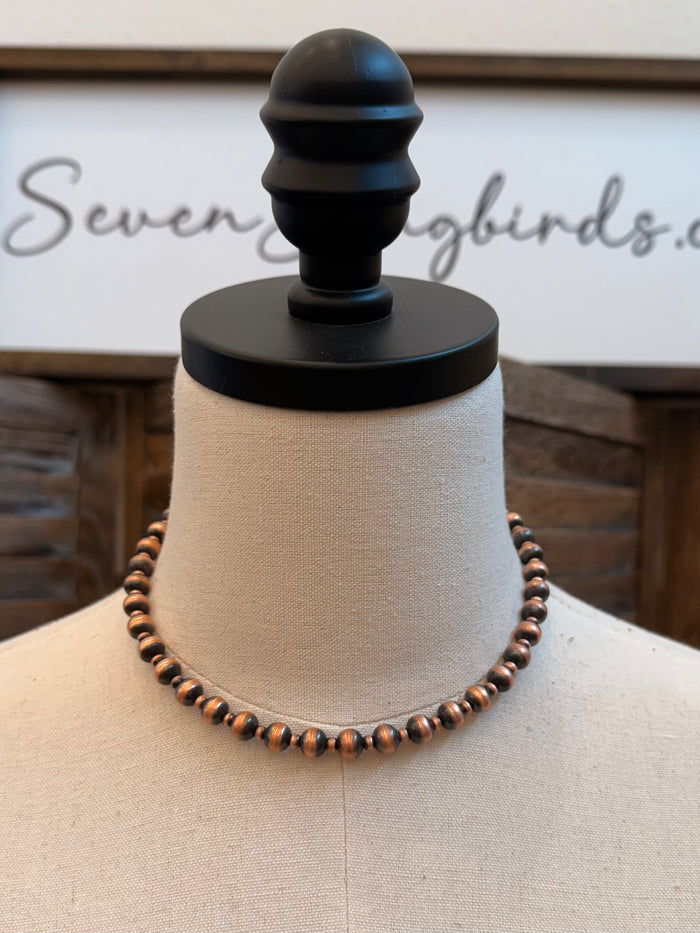 16-inch copper bead necklace, full strand on mannequin