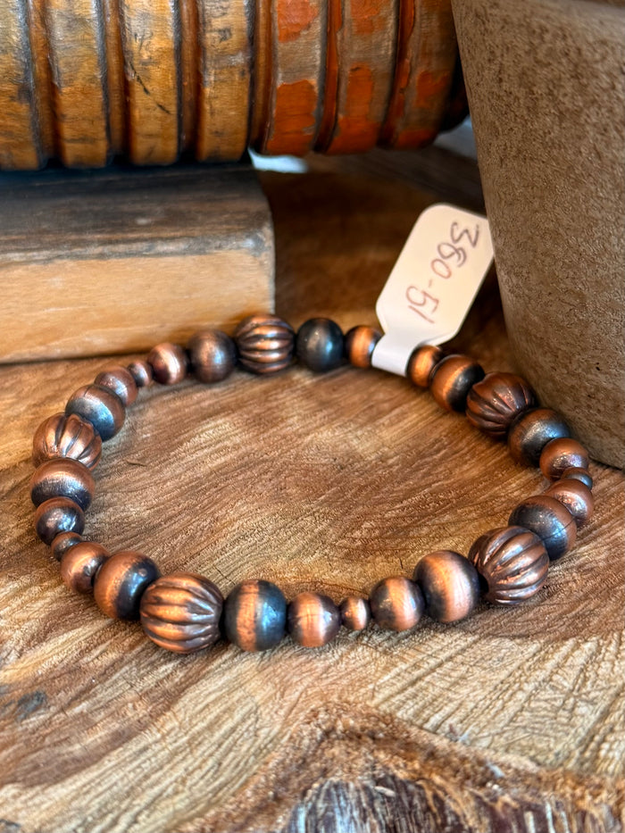 Copper and dark blue beaded stretch bracelet, round stacked bead design