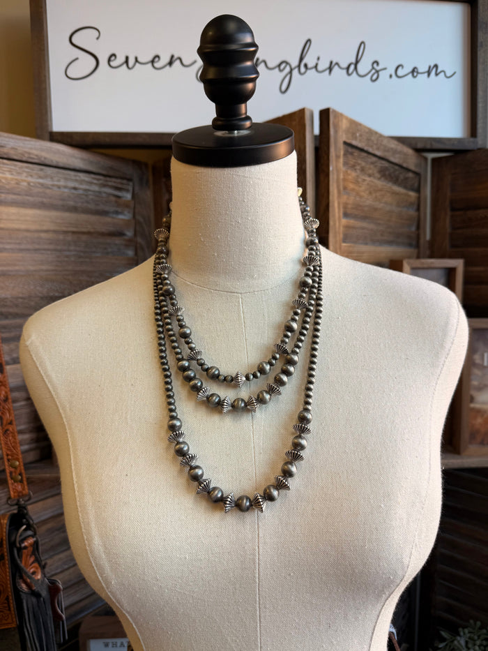 Silver pearl rondelle necklace with graduated beaded rows on a mannequin