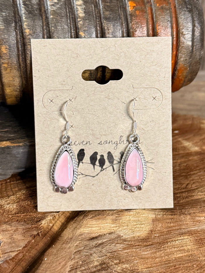Pink teardrop fishhook earrings with ornate silver fringe and blue bead details