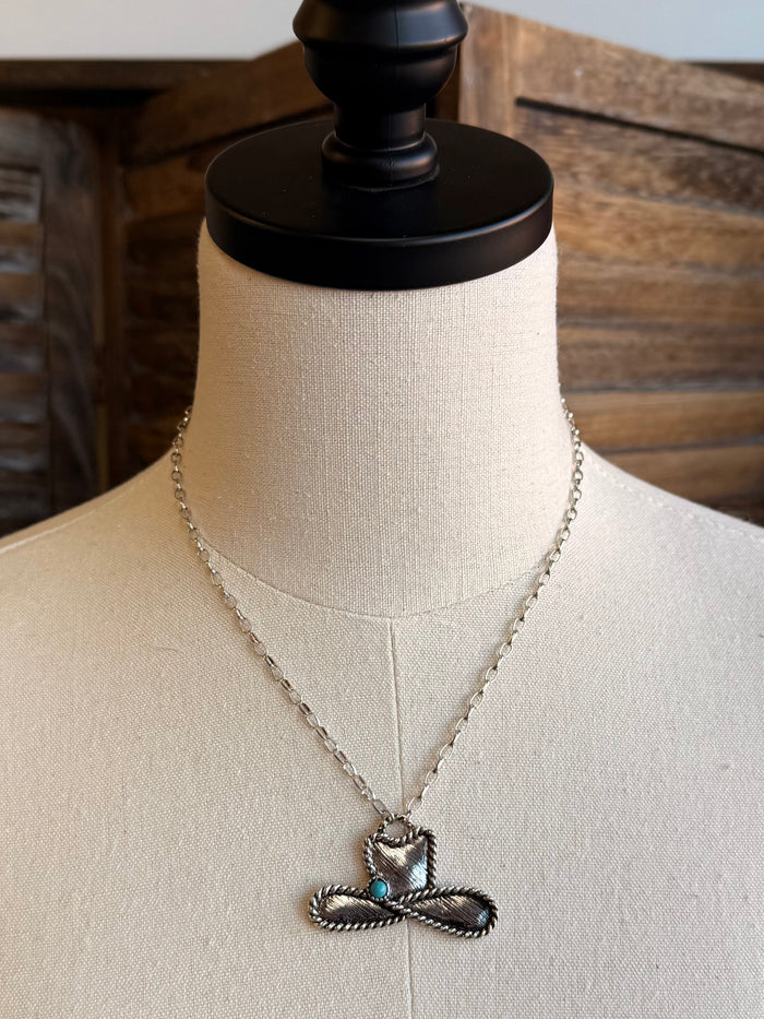 Silver cowboy hat rope necklace with turquoise pendant shown on mannequin