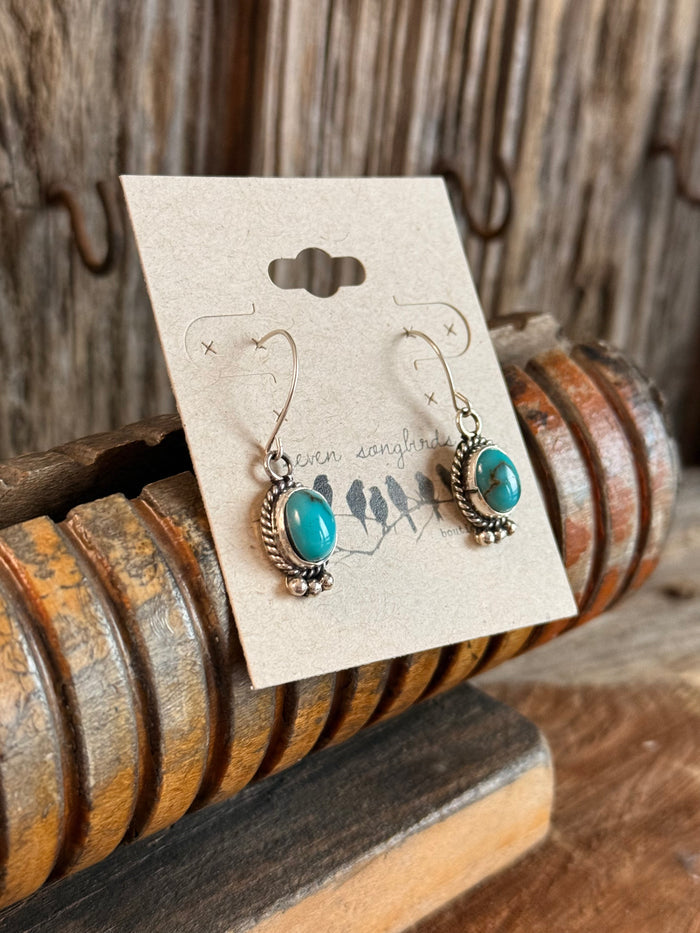 Sterling silver turquoise fishhook earrings with ornate bezel and oval cabochons
