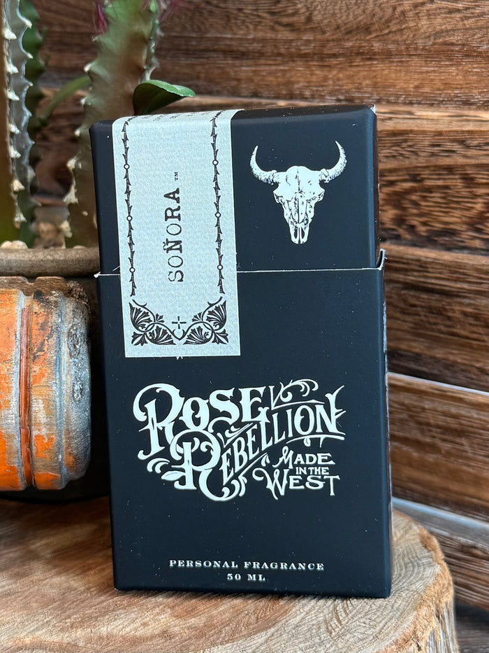 Perfume box with Soñora branding, bull skull graphic, and Rose of Rebellion text