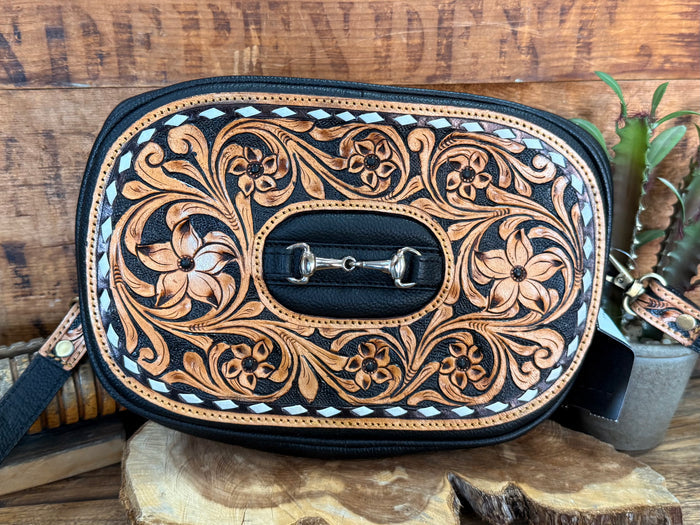 Tooled leather crossbody purse with oval flap, decorative floral pattern, snap buckle
