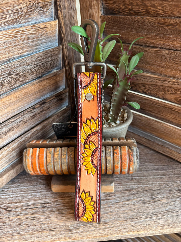 Tooled leather sunflower keychain, orange panel with multiple sunflower prints and silver ring