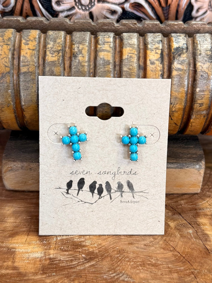Turquoise beaded cross stud earrings on display card, silver-tone posts