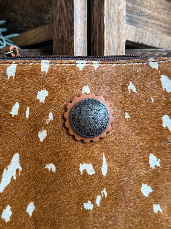 Deer-print cowhide coin crossbody purse closeup, round concho and studded border