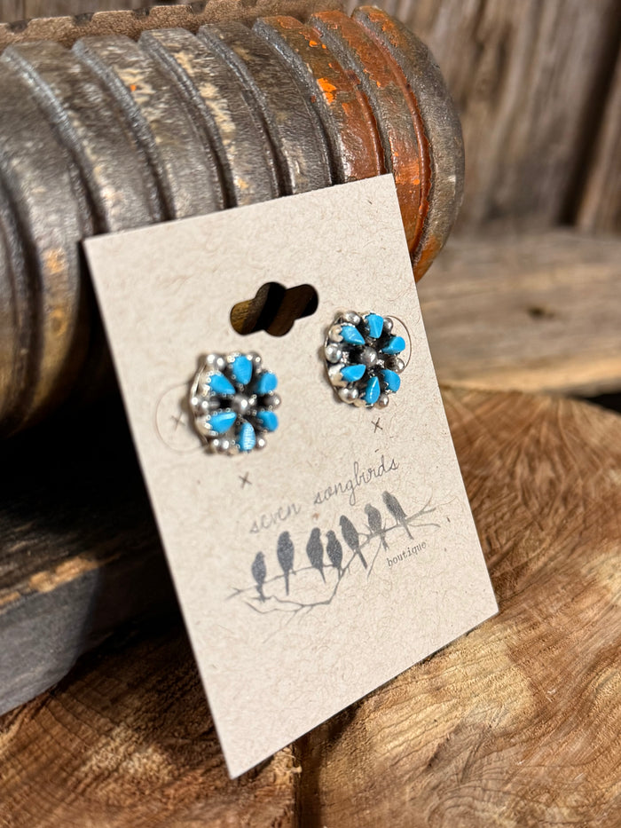 Turquoise blue flower stud earrings, angled view with faceted blue petals