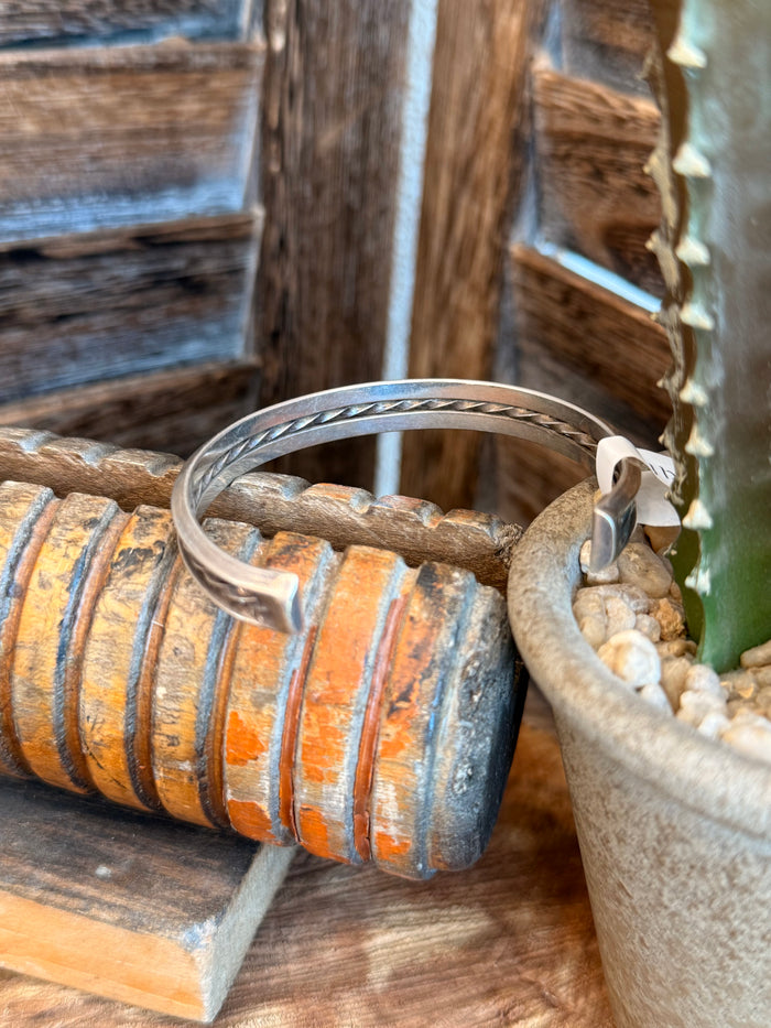 Silver cuff bracelet with smooth open ends and hammered texture