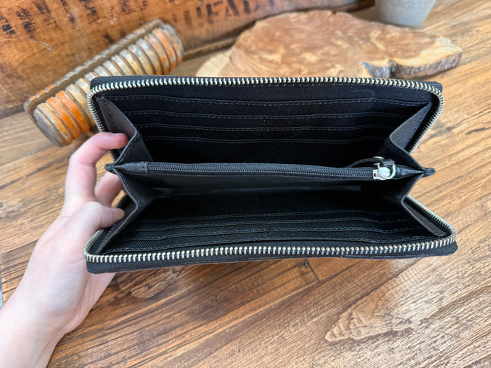 Open leather wristlet wallet interior with card slots and zippered compartments