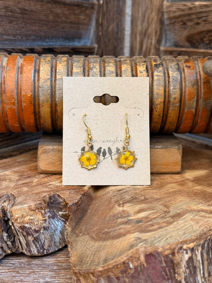 Gold-tone fishhook earrings with yellow dried-flower charm, dangling drop style