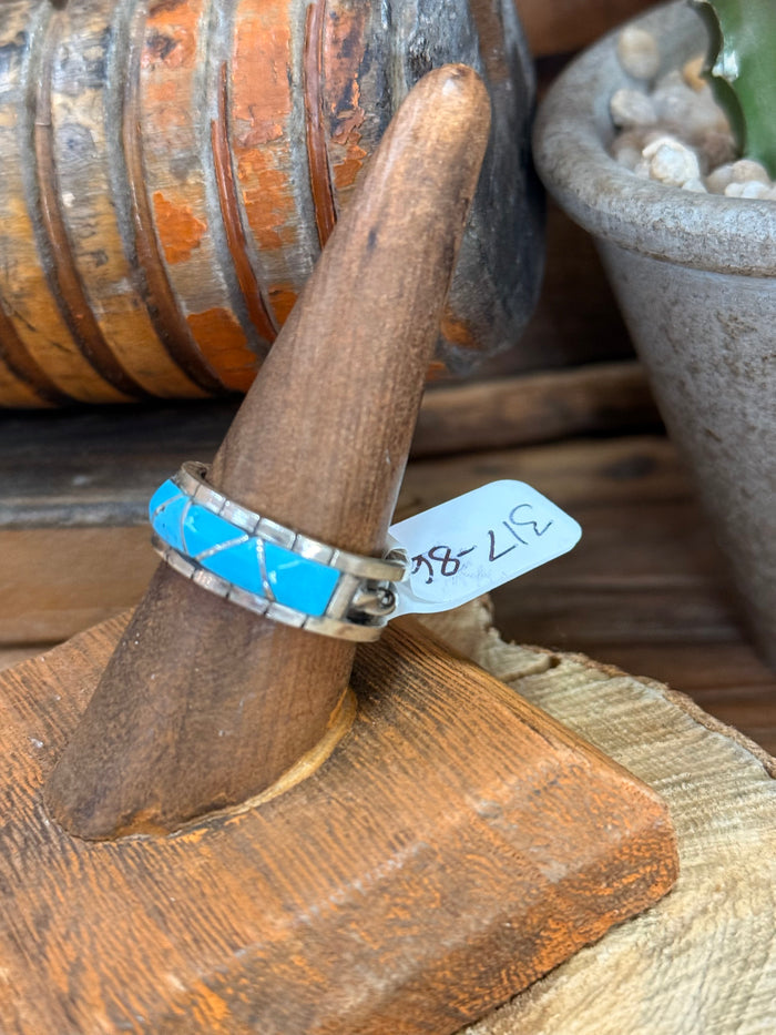 Close-up turquoise inlay ring showing blue stones and polished silver setting