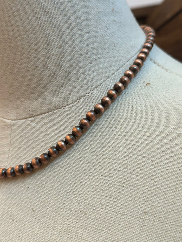 Close-up of 6mm genuine copper bead necklace with round bead texture