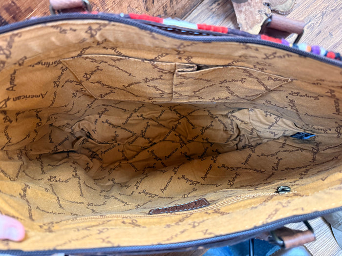Brown leather tote interior with tan patterned lining and visible zipper edge