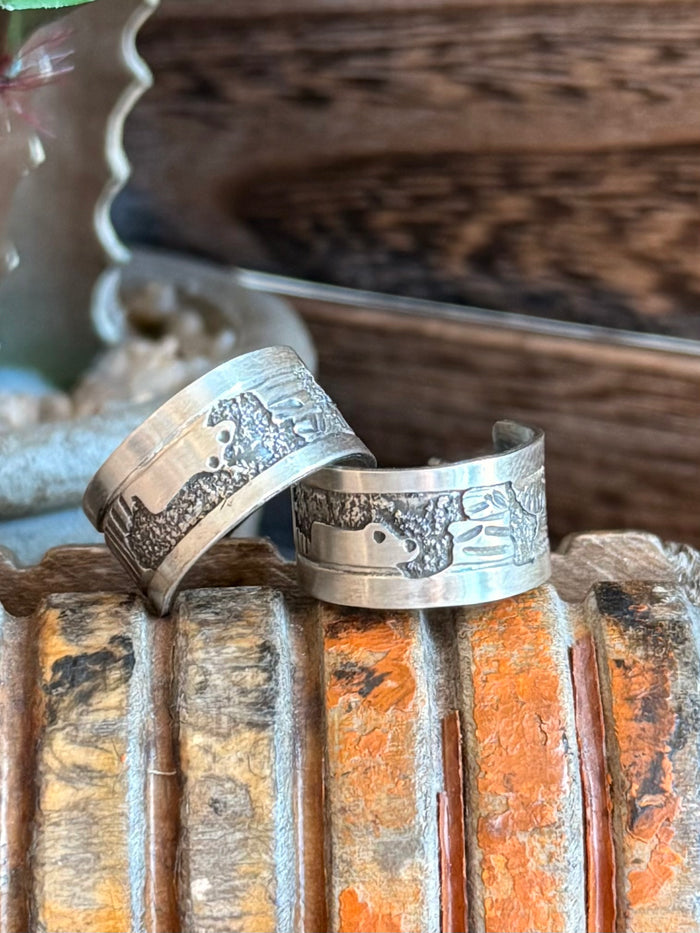 Sterling hoop earrings, engraved band design with textured pattern on the hoop.