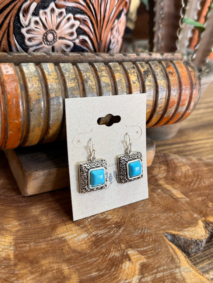 Turquoise square fishhook earrings in silver-tone filigree frames, front view