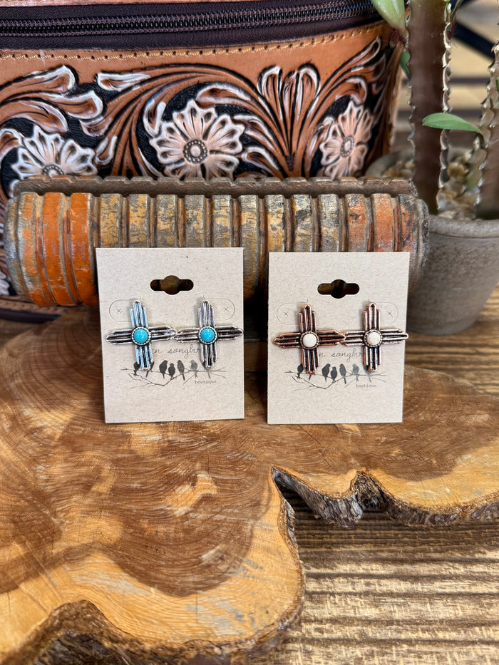 Zia symbol stud earrings with turquoise stones; cactus and ladder charms on display card