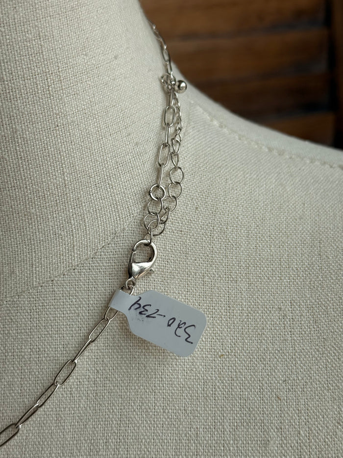 Turquoise lightning bolt pendant necklace with small engraved tag and silver chain