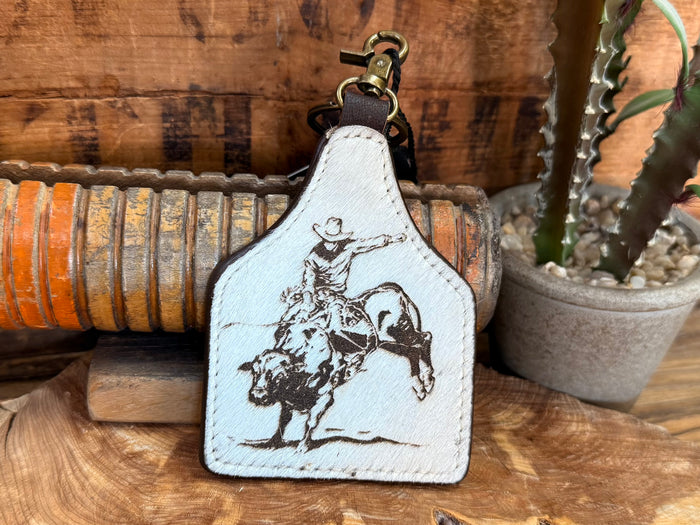 Hair-on key fob with white patch and detailed bull rider silhouette