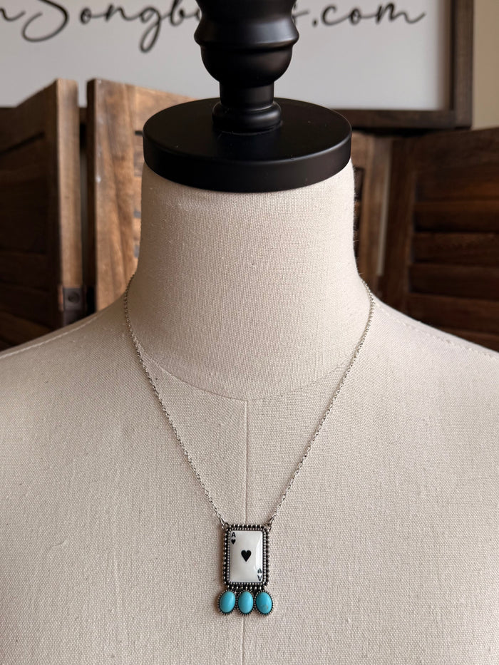 Silver-tone chain necklace with rectangular ace charm and three turquoise beads