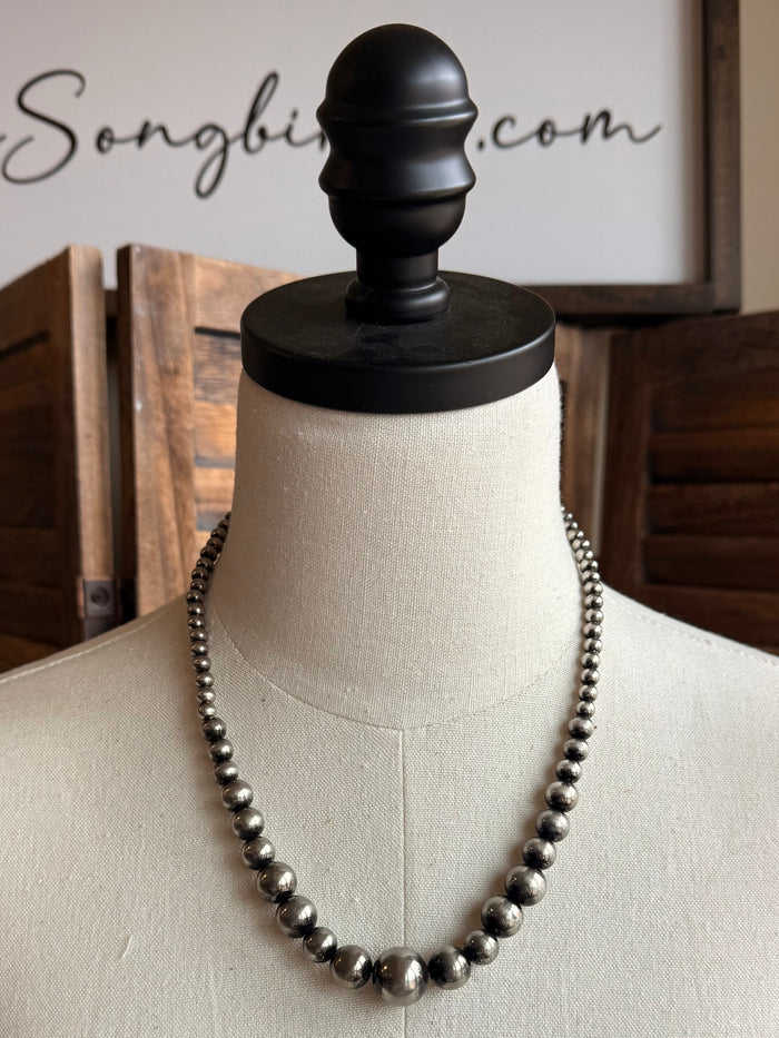 Graduated silver pearl bead necklace, close view of rounded bead strand