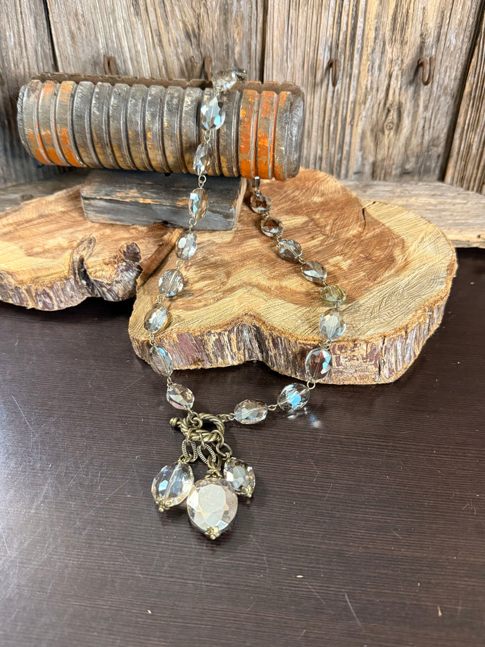 Faceted clear crystal necklace with linked chain and heart-shaped charm pendant