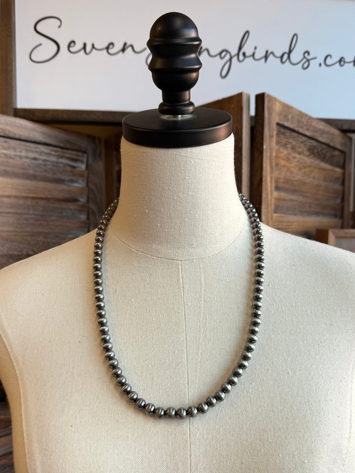 24-inch silver ball chain necklace with round bead links on display