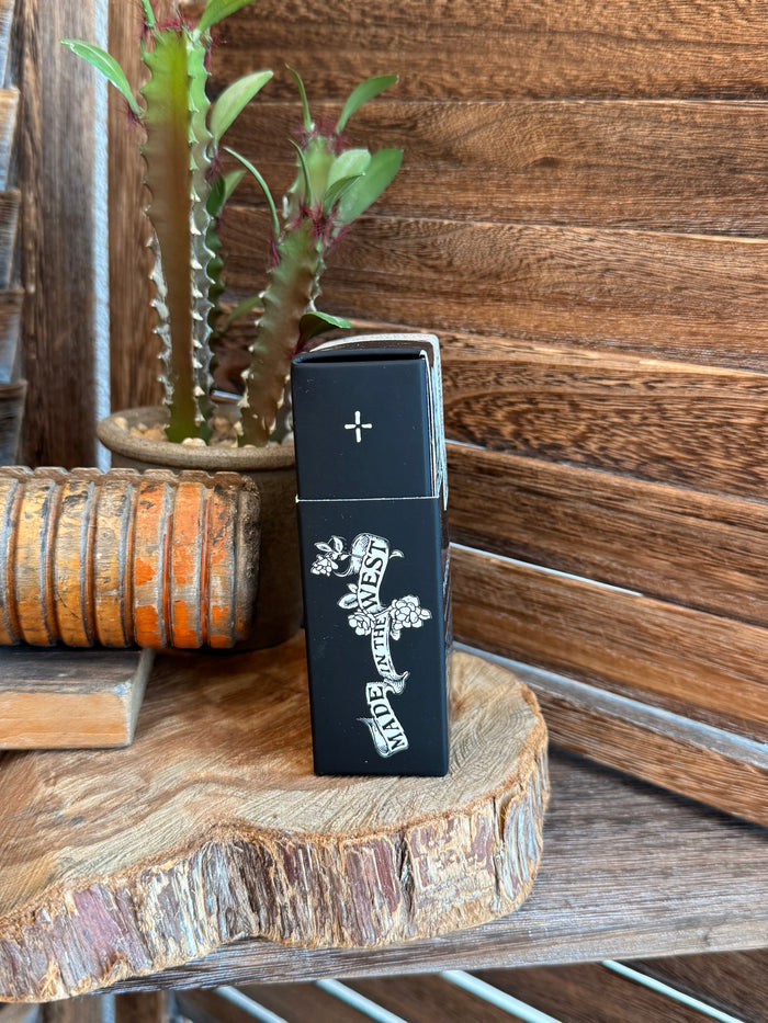 Dark blue perfume box side with white cross and text along the edge