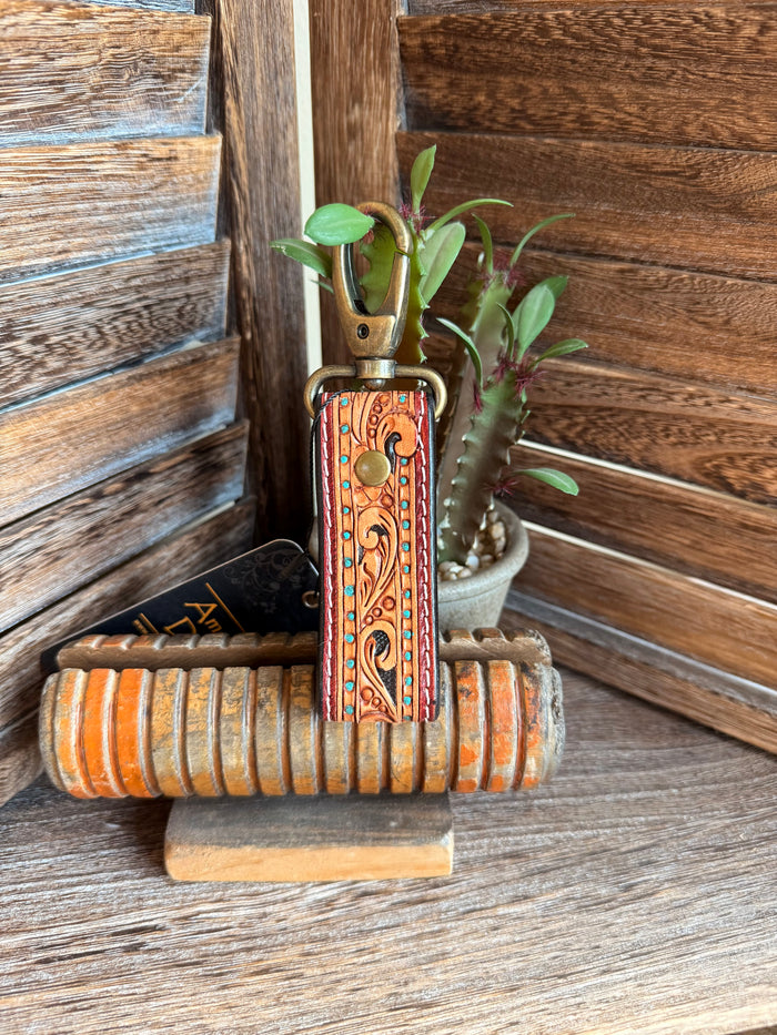 Tooled leather keychain with turquoise-edge orange strap and brass metal key ring