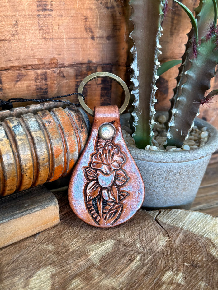 Teardrop cowhide key fob with carved rose and leaf motif, tan leather and metal ring