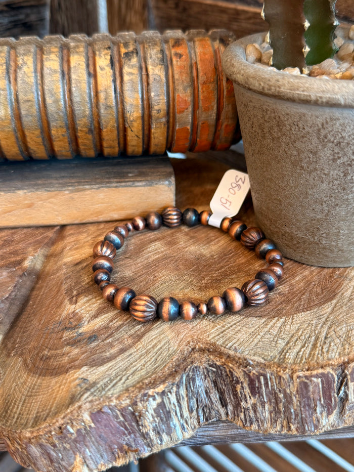 Copper bead stretch bracelet with dark blue spacer beads, 4–8 mm