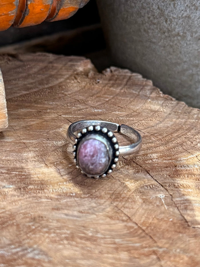 Adjustable silver-tone ring with purple oval gemstone and scalloped beaded halo setting