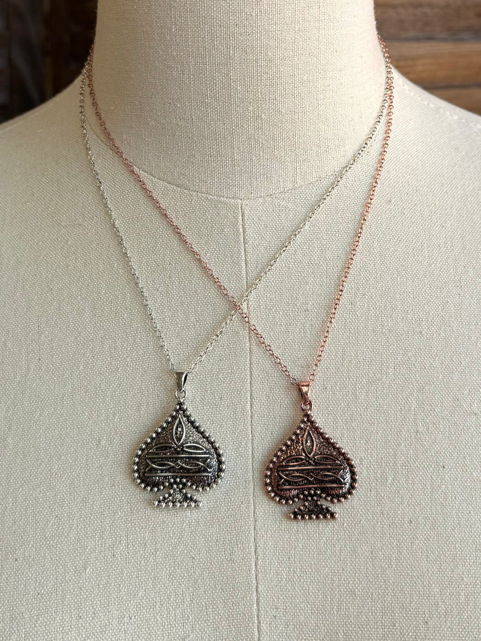 Spade pendant necklaces on mannequin, silver and copper teardrop spade charms on two chains