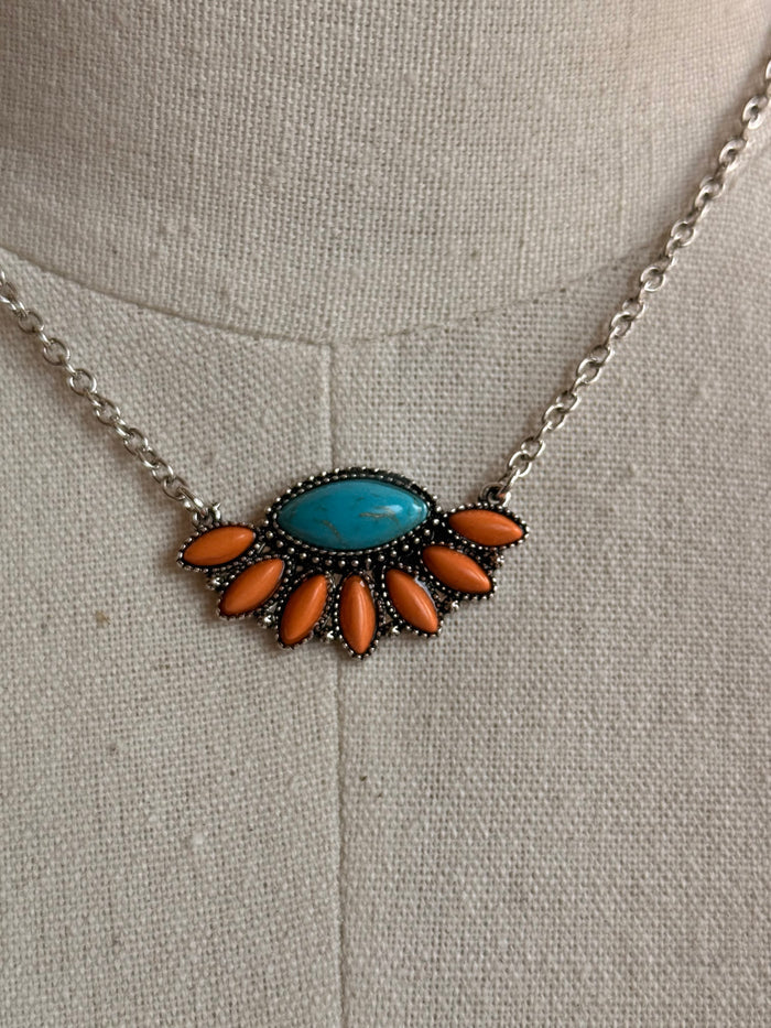 Orange and turquoise fan pendant necklace with oval blue center and leaf petal accents