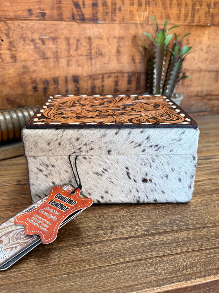 Hair-on jewelry box with carved brown lid, black-and-white hide, hanging tag