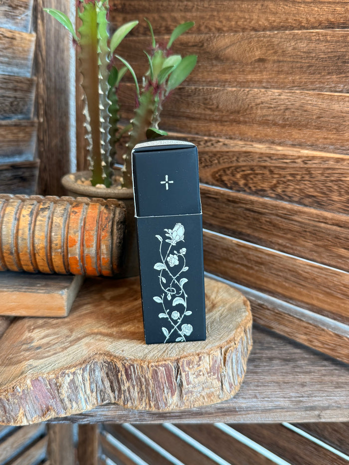 50 mL perfume box side, black with white cross and vine artwork