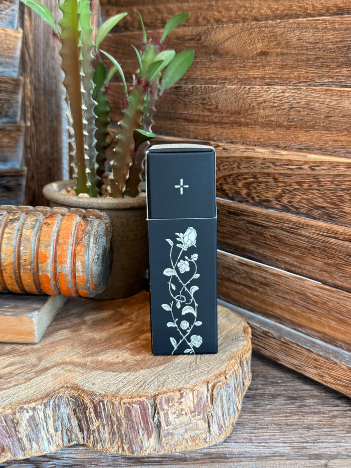Soñora 50mL perfume box, black with white floral vine design and cross icon