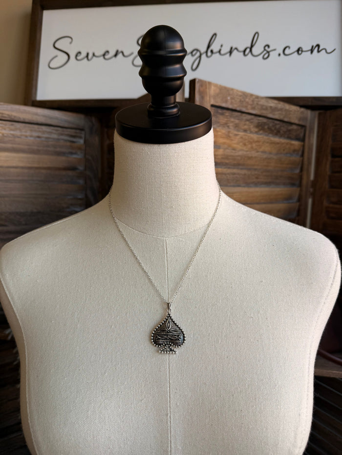 Silver spade pendant necklace with long chain on mannequin