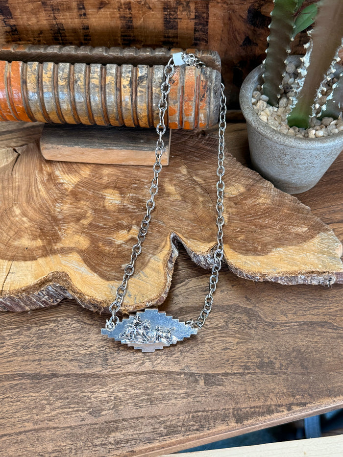 Silver-tone pendant necklace with long chain and textured sunburst charm