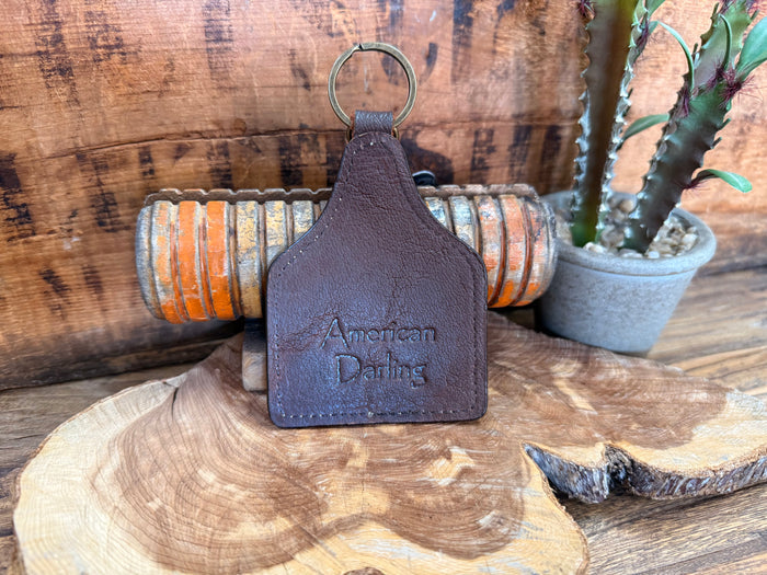 Brown leather key fob back with 'American Darling' text and metal keyring