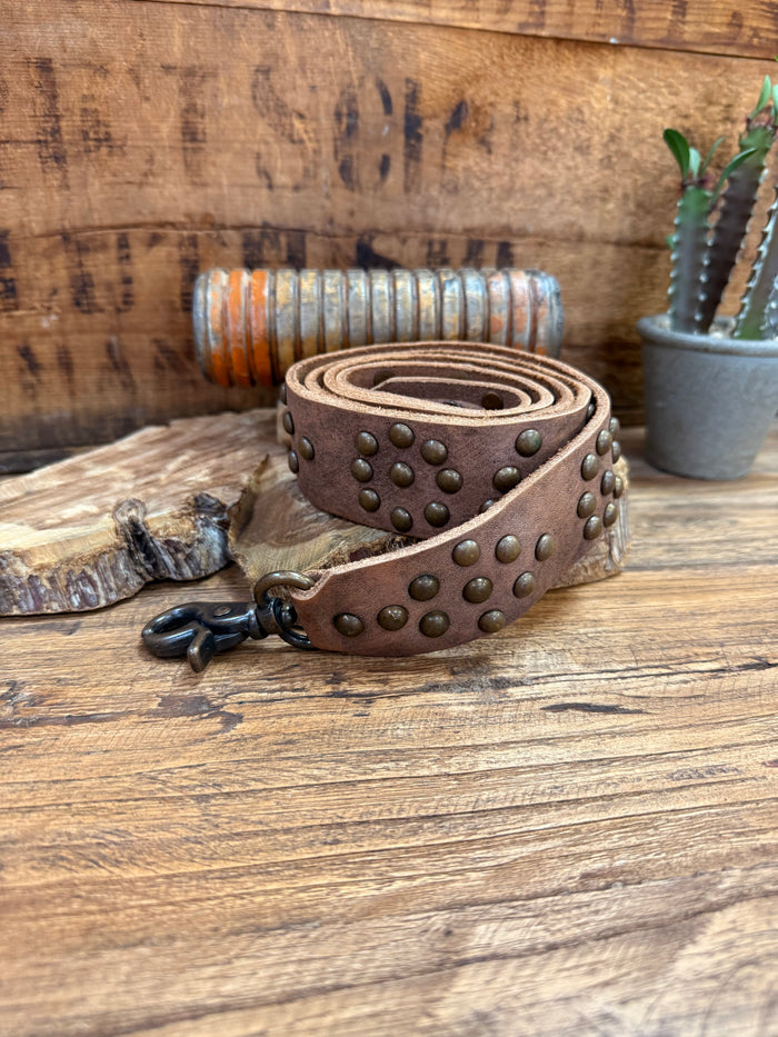 Brown leather purse strap with brass studded trim and metal ring clasp