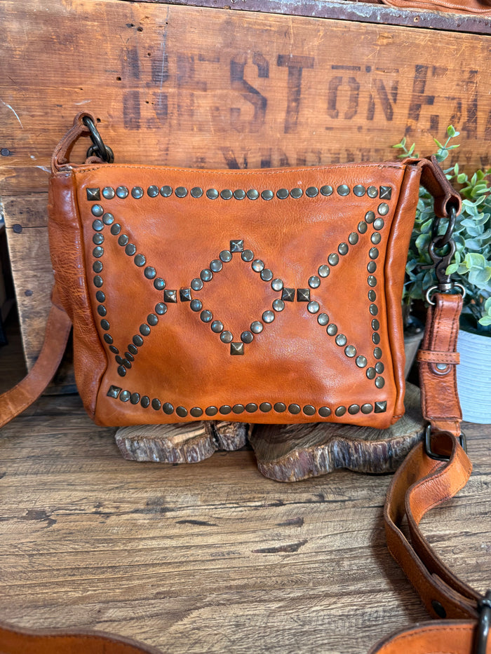 Studded cognac leather flap crossbody purse with heart-shaped stud pattern