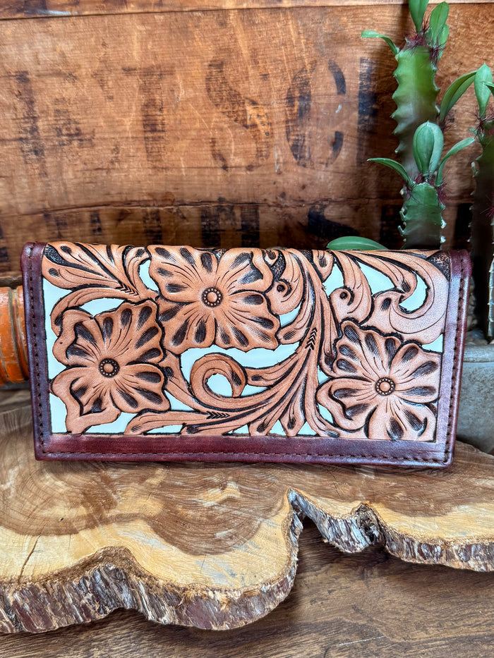 Floral tooled checkbook wallet front, tan embossed flowers on dark purple leather with border