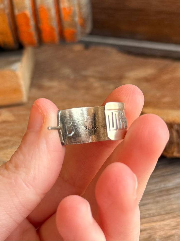 Close-up of sterling hoop earring clasp and post, stamped with STERLING marking.