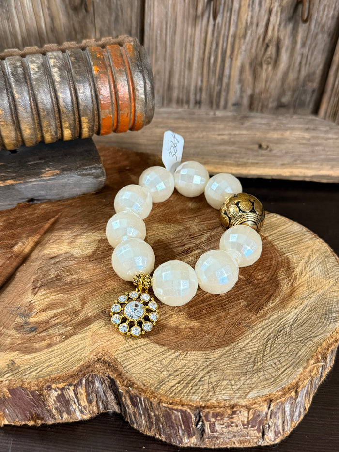 Pearl gold crystal charm stretch bracelet with round white opal beads and floral charm