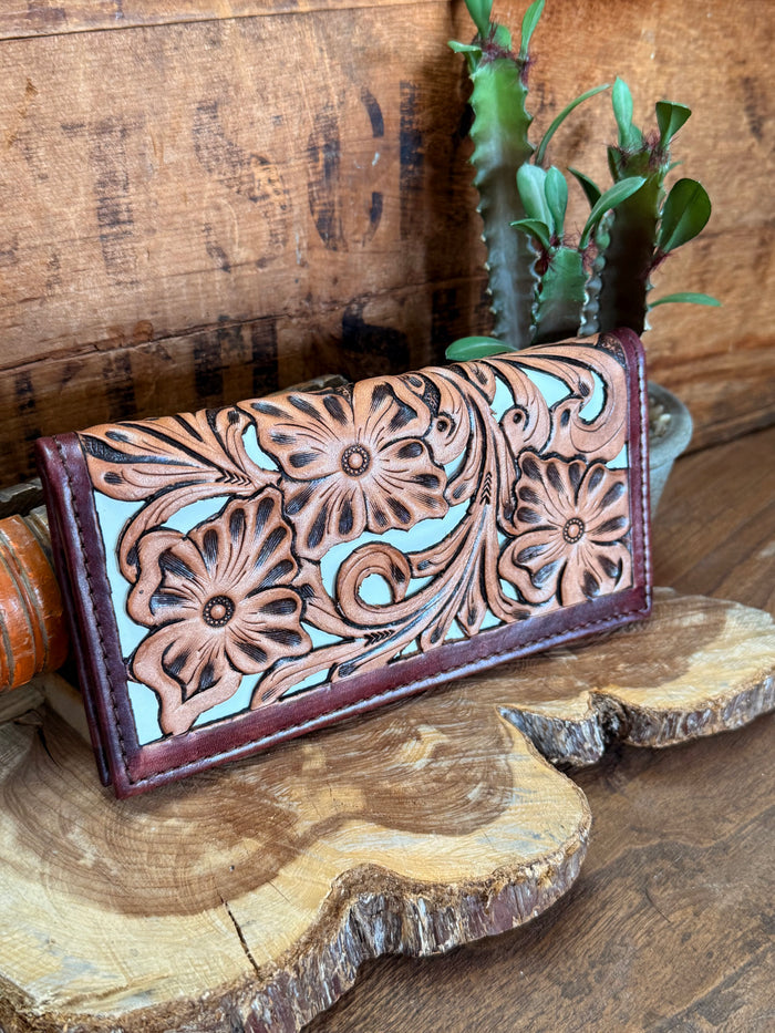 Floral tooled checkbook wallet angled view, carved floral tooling with stitched edge on dark purple
